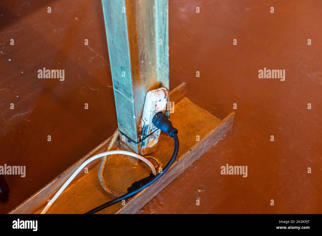 The extension power strip, power cord old and damaged on the construction site outdoor