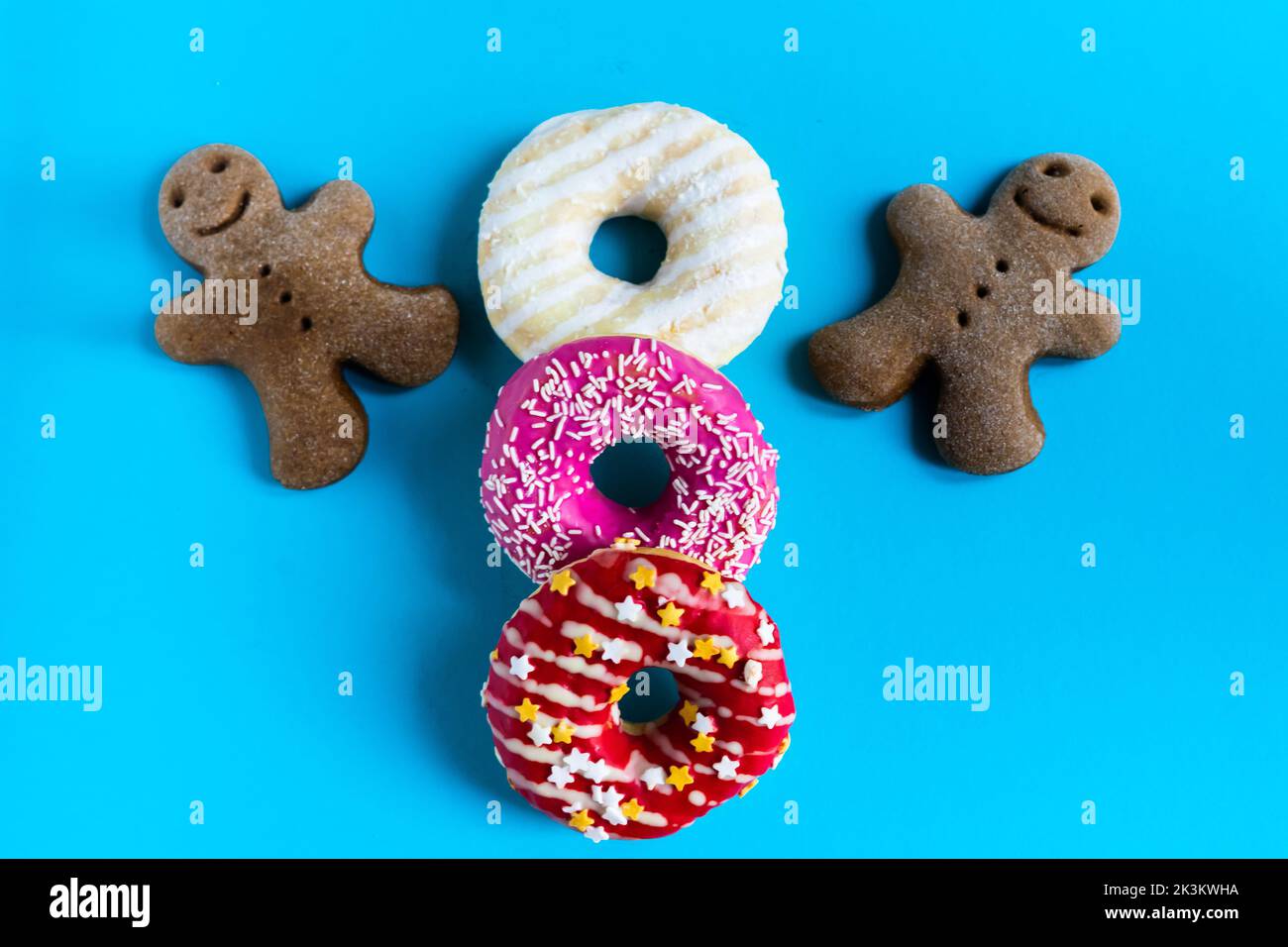 Donut with hazelnuts on blue background, close up Stock Photo