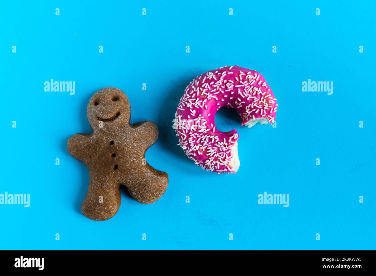 Donut with hazelnuts on blue background, close up Stock Photo