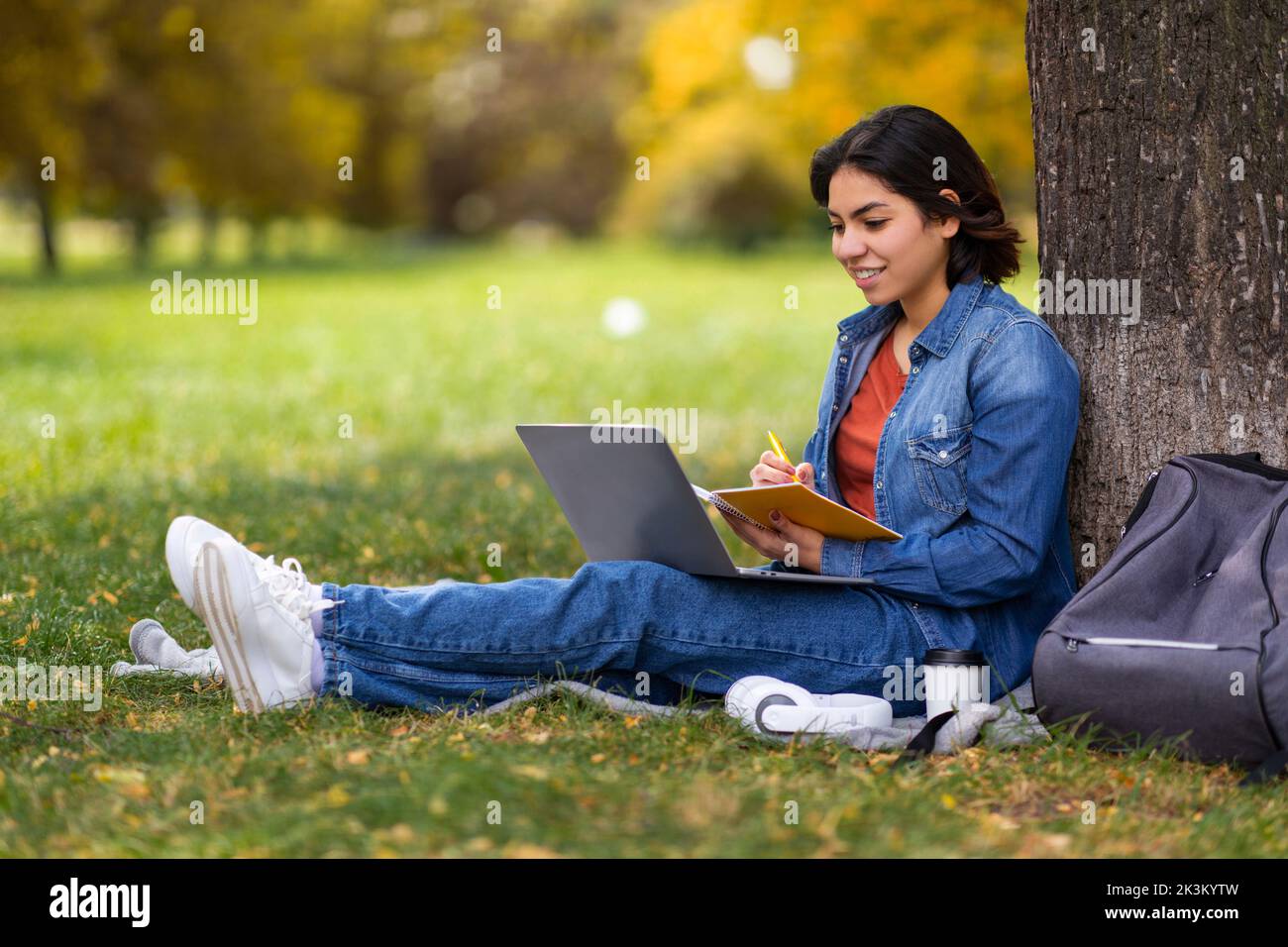 Remote Lesson. Beautiful Young Arab Female Student Study Outdoors With ...