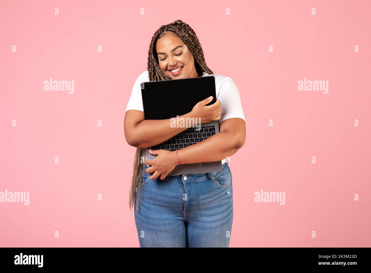 Happy Black Freelancer Woman Hugging Laptop Computer Over Pink Background Stock Photo