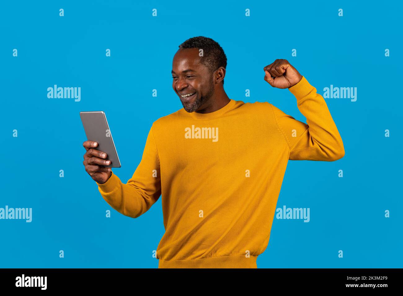 Emotional black man using digital tablet and gesturing Stock Photo