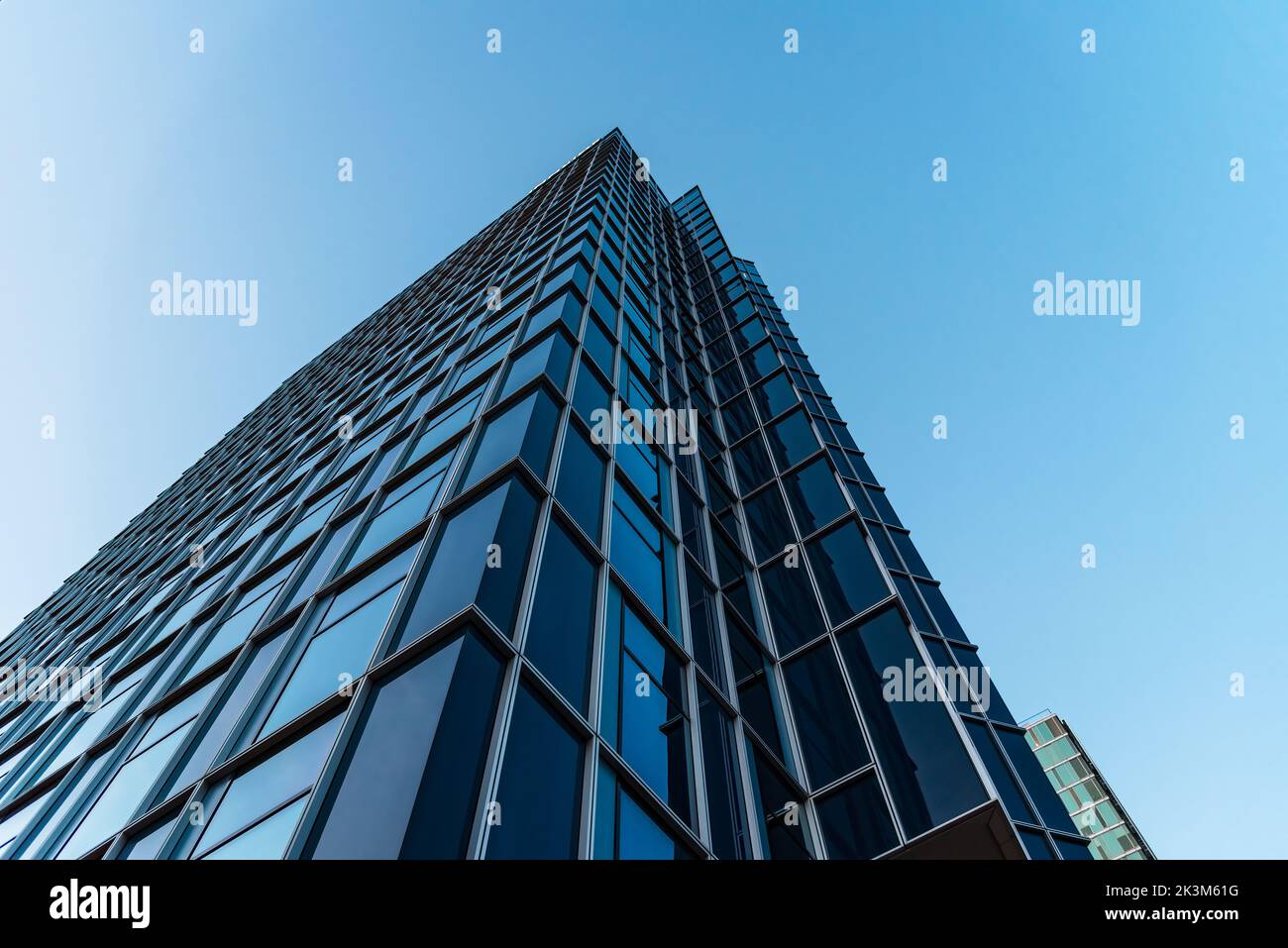Amsterdam, Netherlands - May 7, 2022: Skyscraper against sky. Contemporary architecture, blue colors. Low angle view Stock Photo