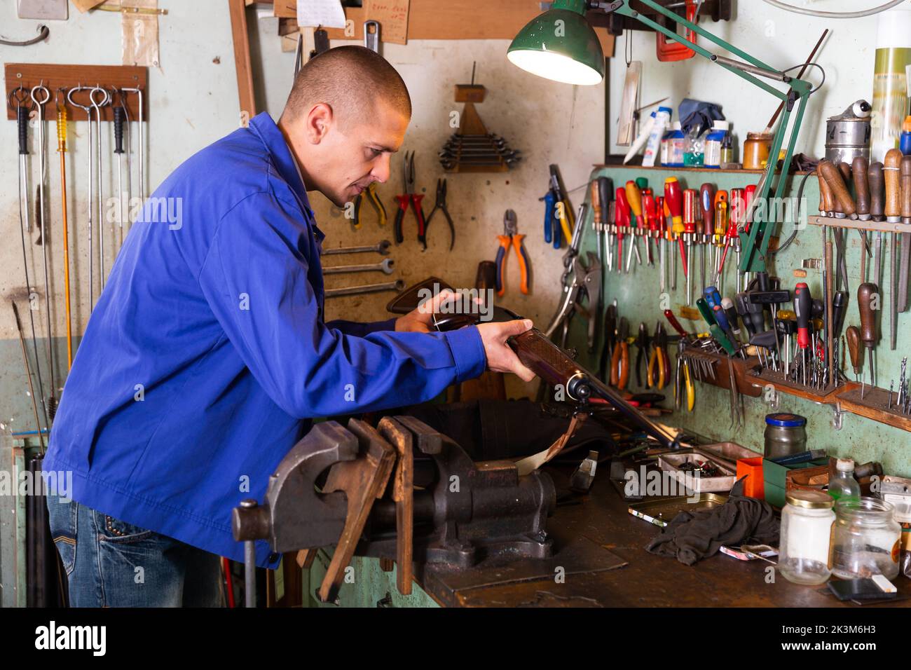 Gunsmith examines and checks appearance of the semi automatic rifle