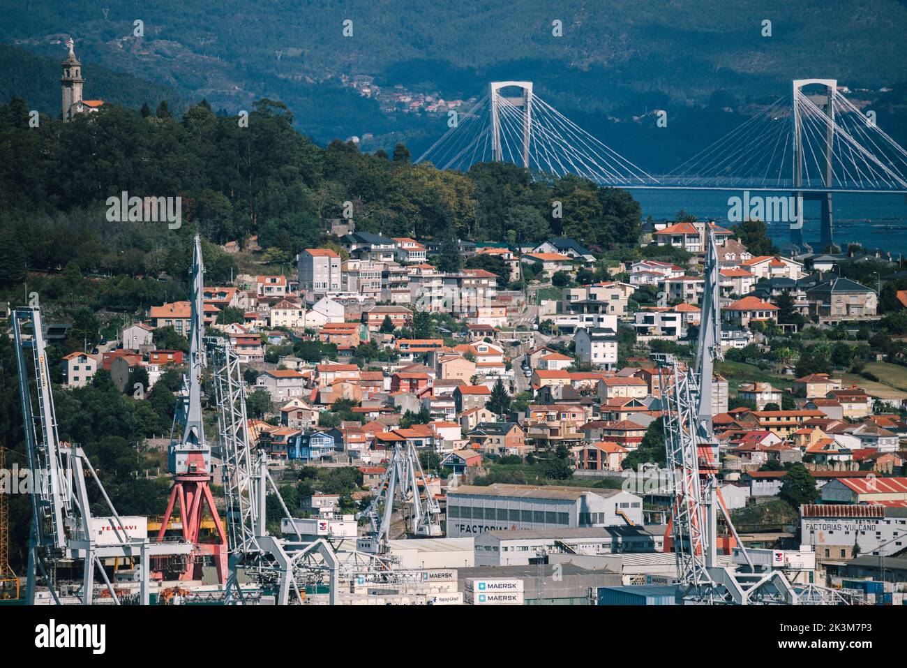 Vigo, Spain - September 24, 2022: High perspective view of Rande bridge in the Vigo estuary, Galicia, Spain with container port in the foreground Stock Photo