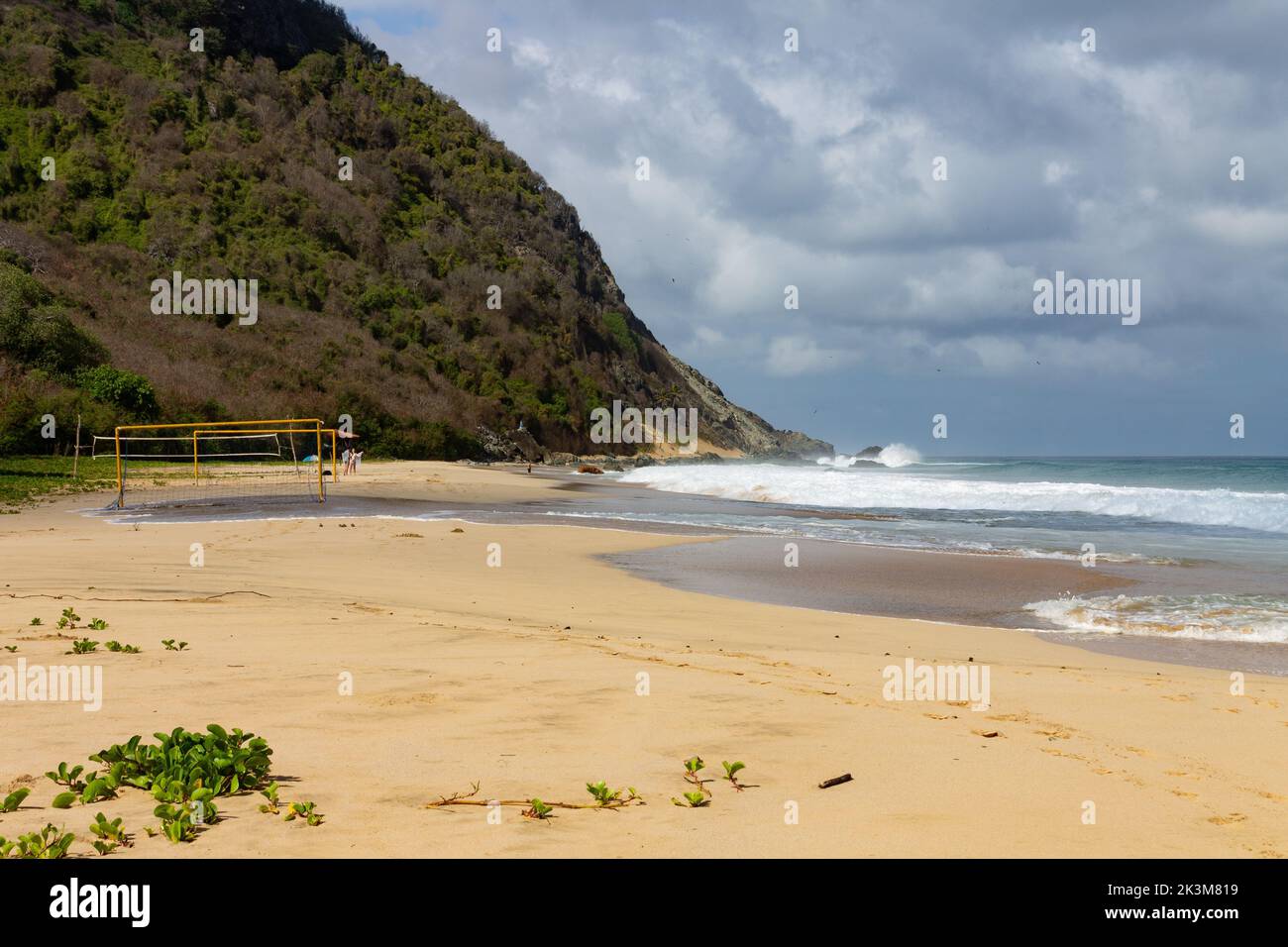 The sandy Praia da Conceicao beach under blue cloudy sky in Pernambuco ...