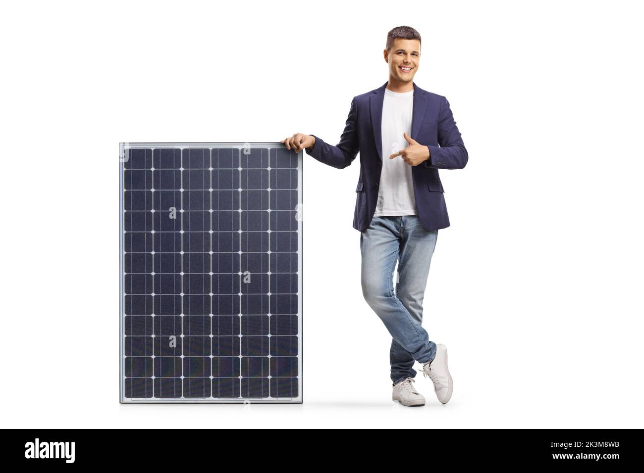 Young man leaning on a solar panel and pointing isolated on white ...