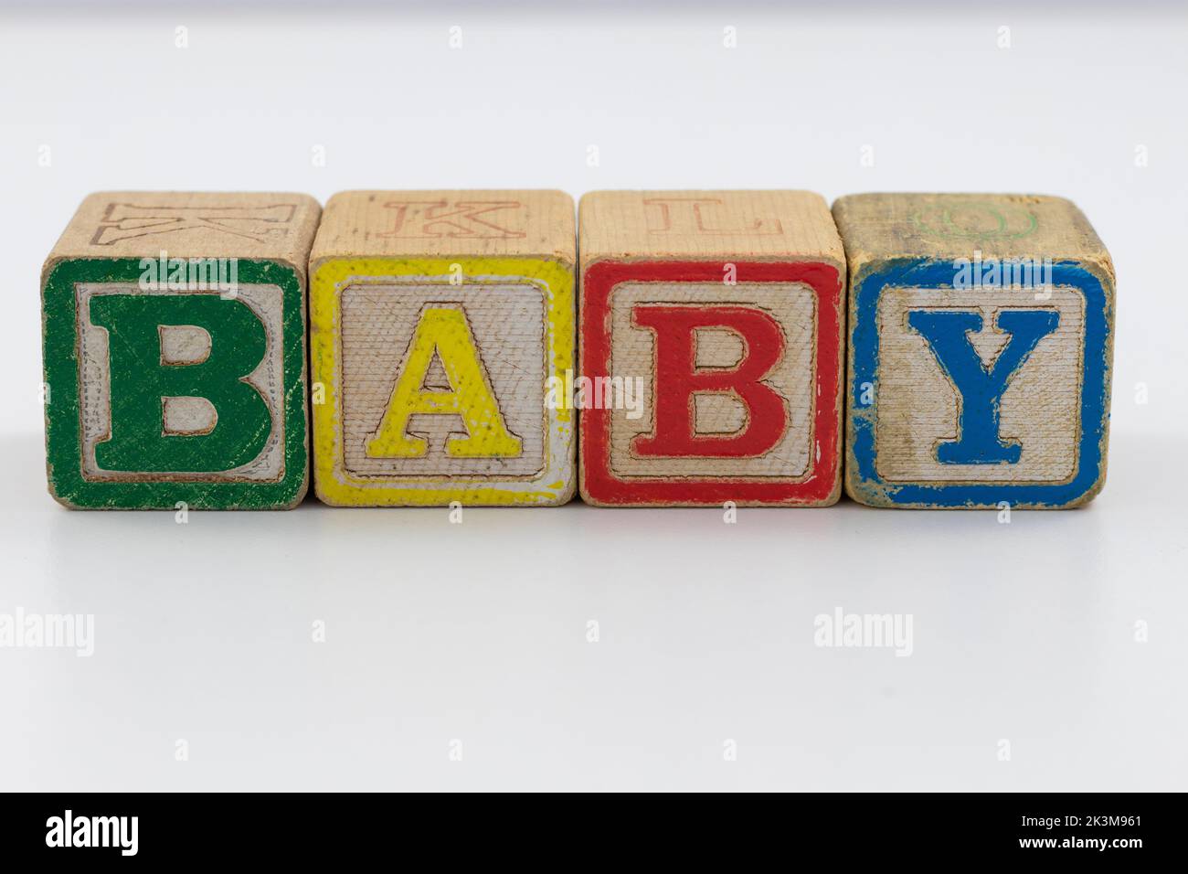 A closeup shot of wooden child toy block spelling out baby on a white background Stock Photo