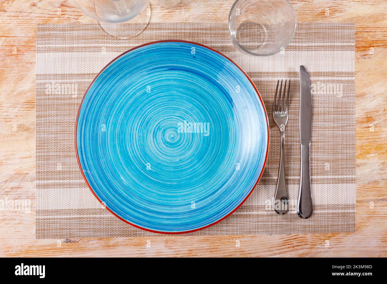 Empty plate with fork and knife Stock Photo - Alamy