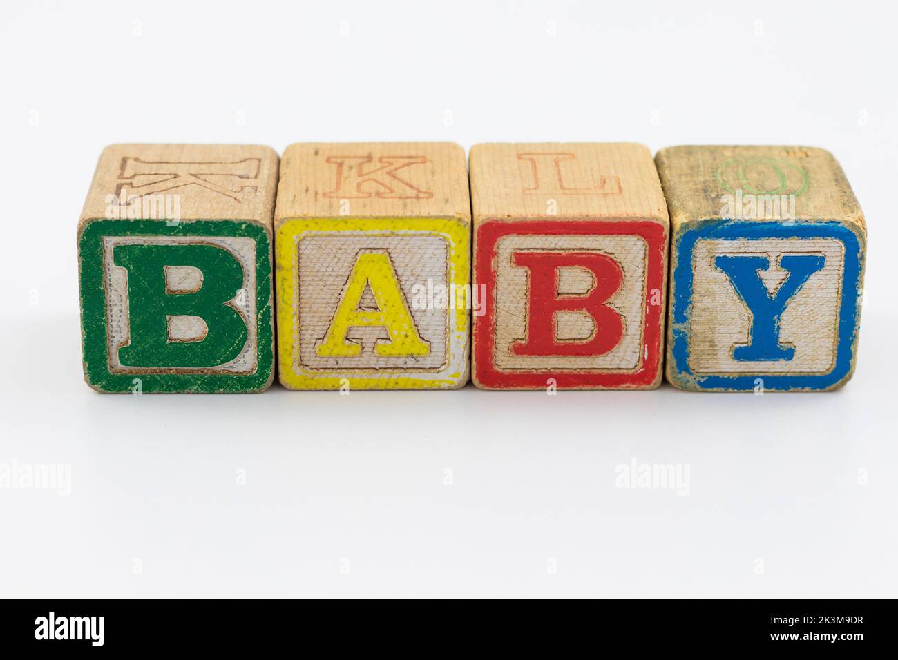 A closeup shot of wooden child toy block spelling out baby on a white ...