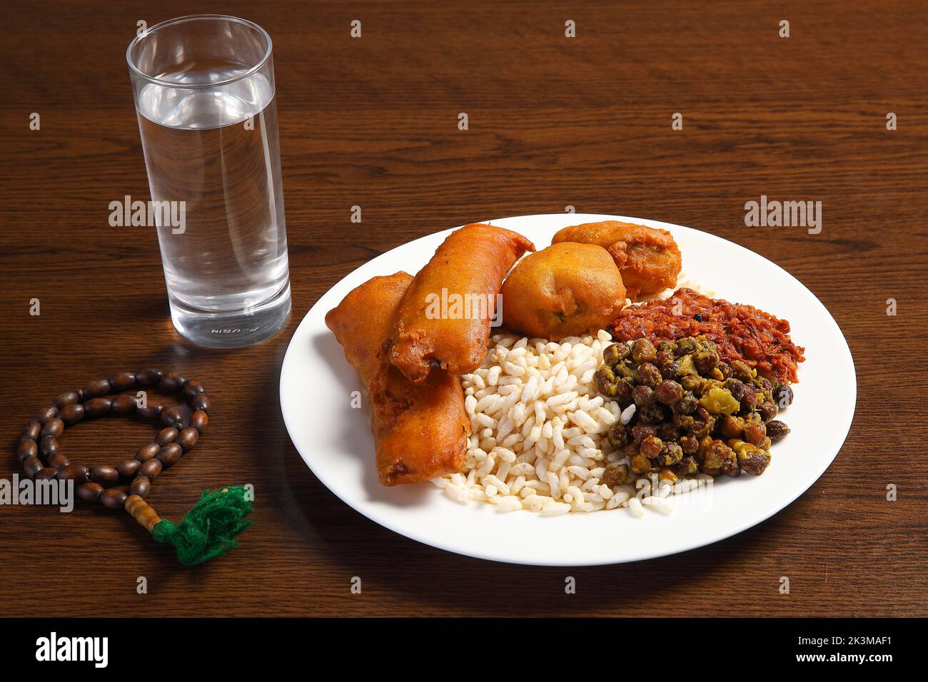 Ramadan Kareem and iftar muslim food, holiday concept. Trays with nuts and dried fruits and latterns with candles. Stock Photo