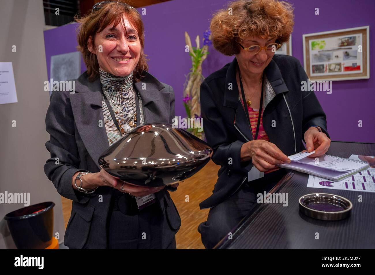 Paris, France,  Woman Artist Holding Urn in Hands, Urns on Display at Death Trade SHow 'Salon de la Mort' Stock Photo