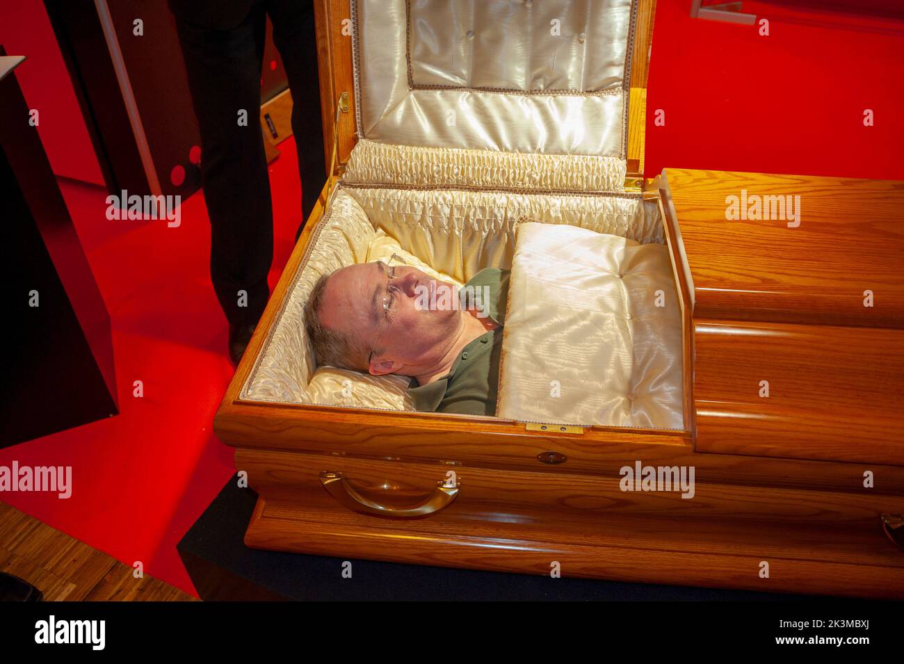 Paris, France, Man in a Casket on Display at Death Trade SHow 'Salon de la Mort' Stock Photo