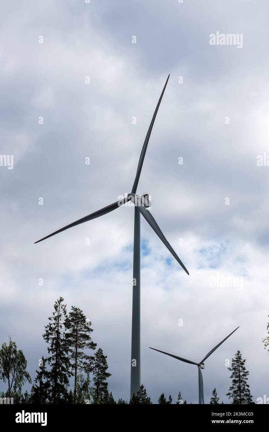 Wind turbines against the cloudy sky in summer, Otanmäki, Finland Stock Photo