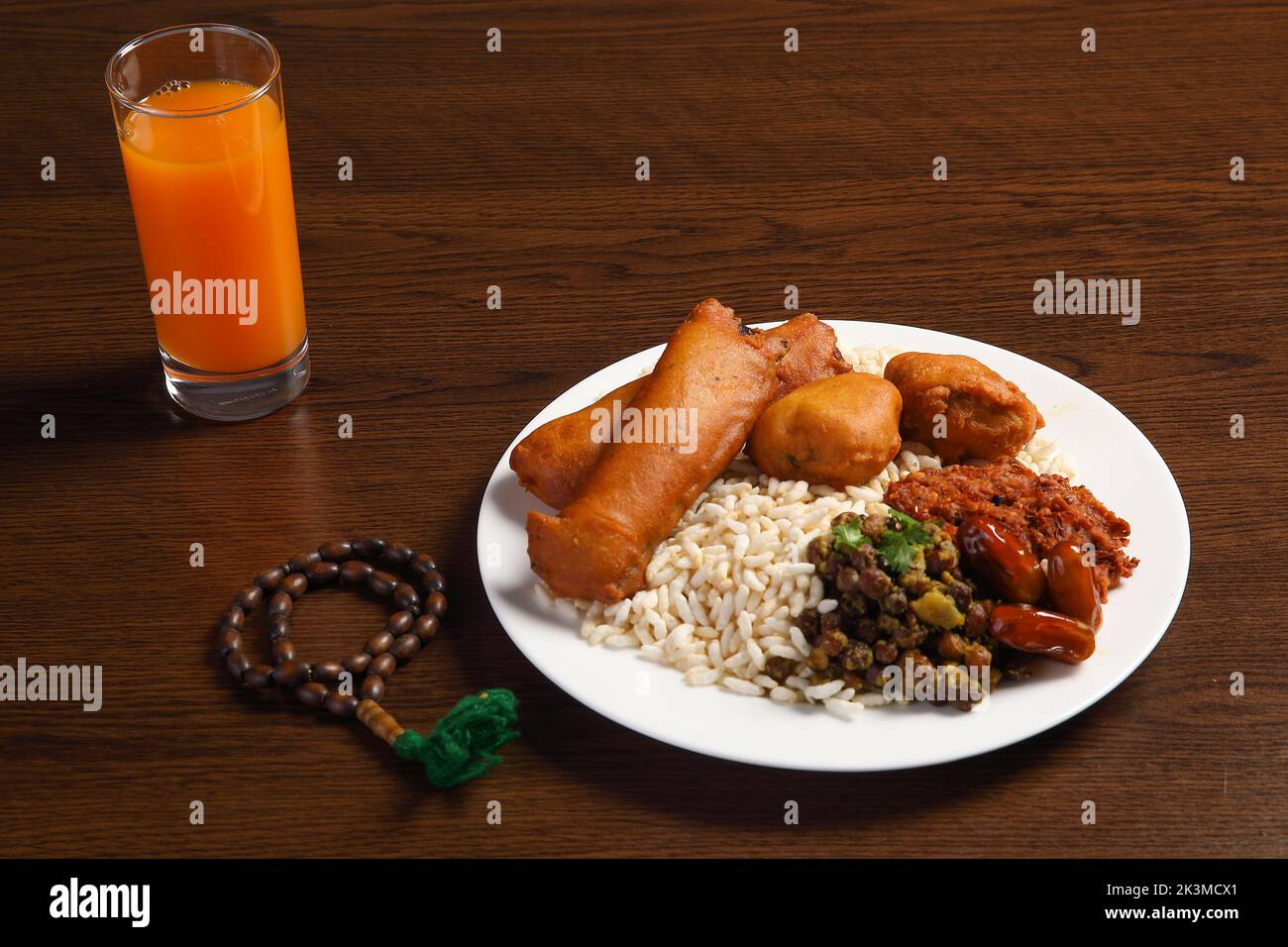 Ramadan Kareem and iftar muslim food, holiday concept. Trays with nuts and dried fruits and latterns with candles. Stock Photo