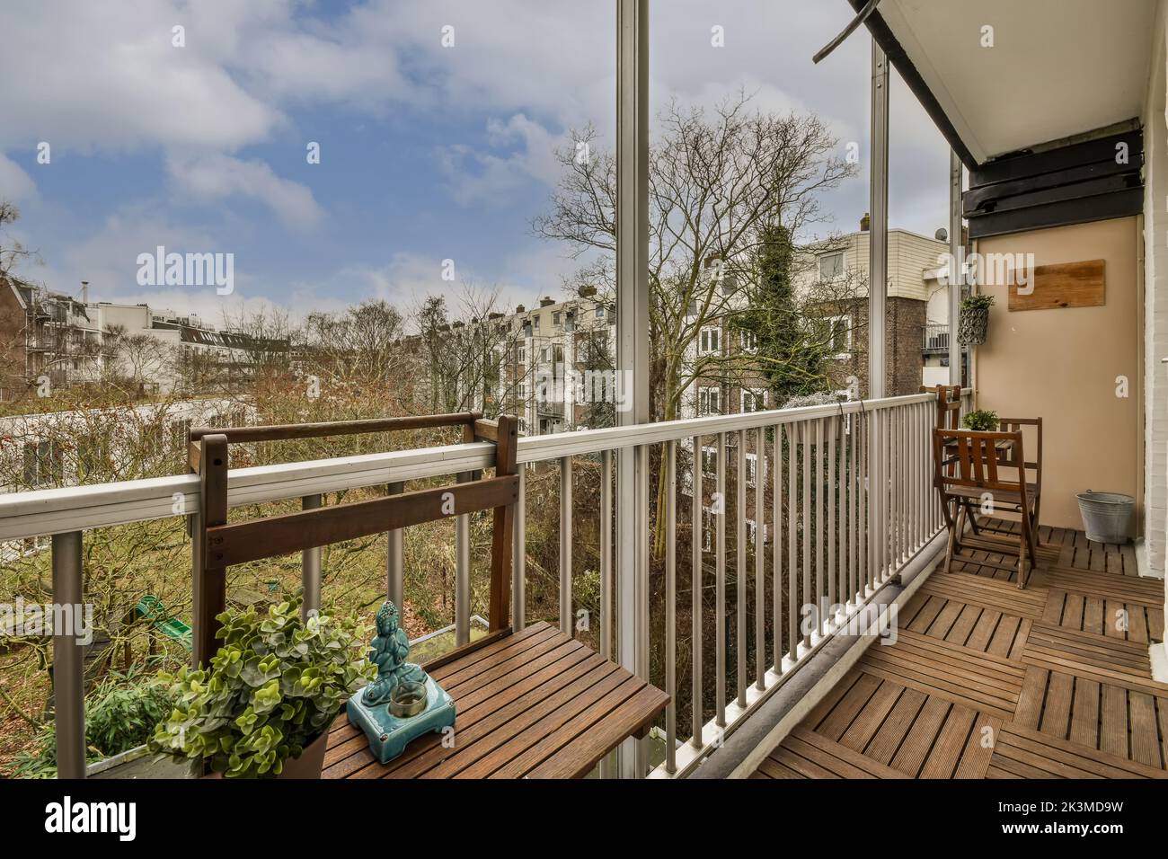 Wooden folding chairs placed at round table near bar shelf at metal