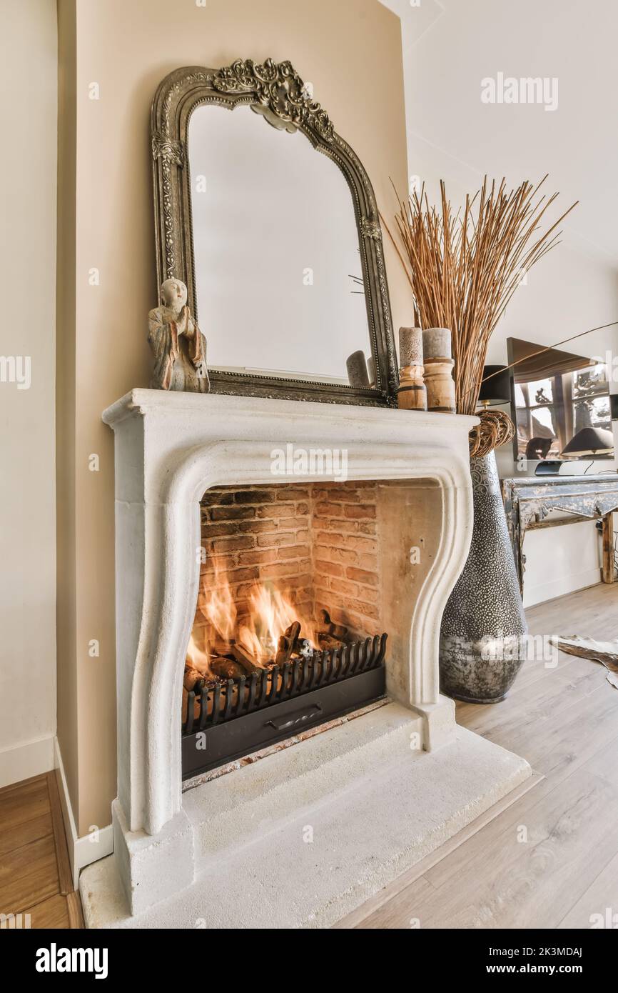 Side view of a lit indoor fireplace in a modern house Stock Photo - Alamy
