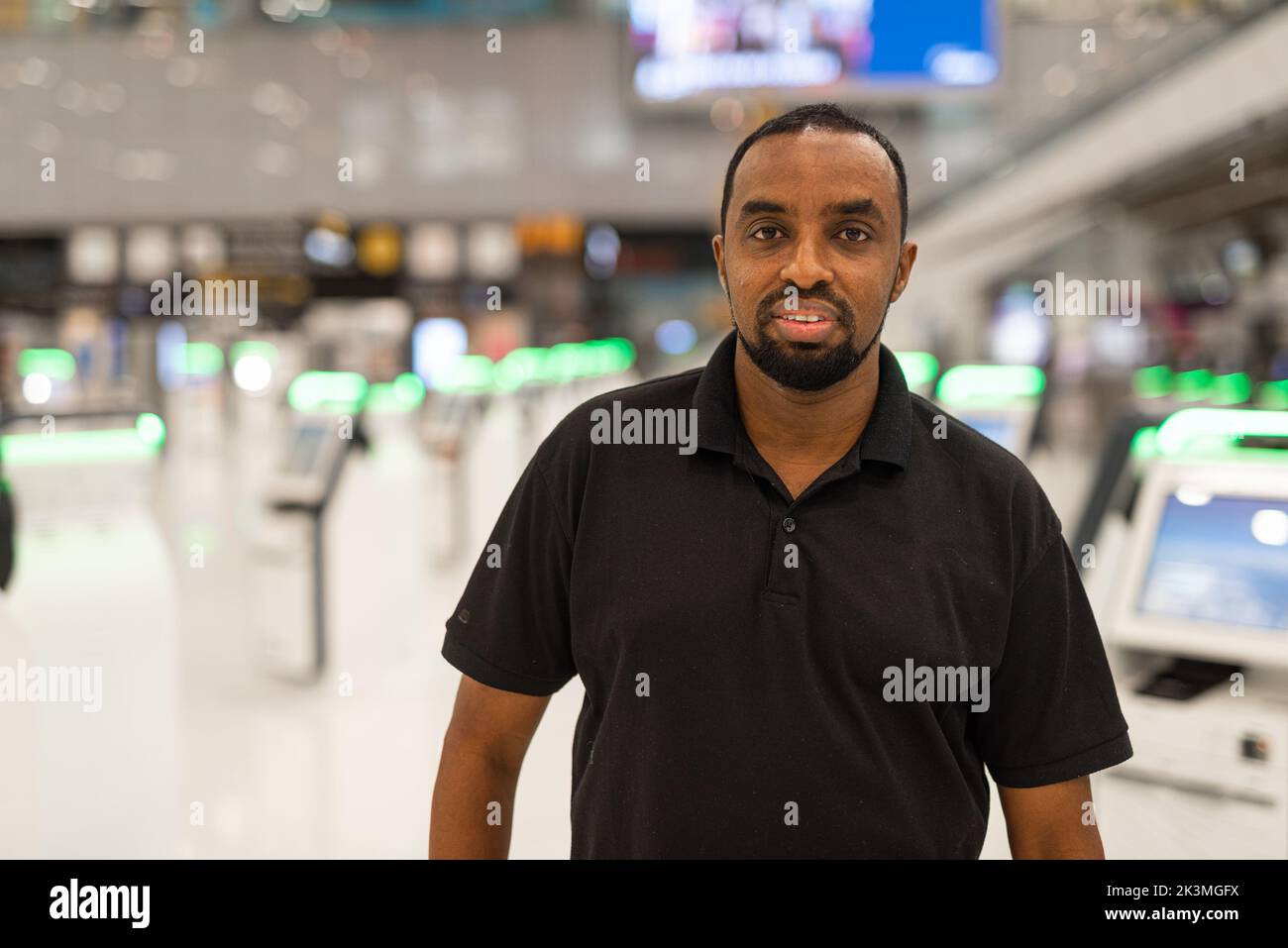 Portrait of African man ready to travel at airport terminal waiting for flight Stock Photo