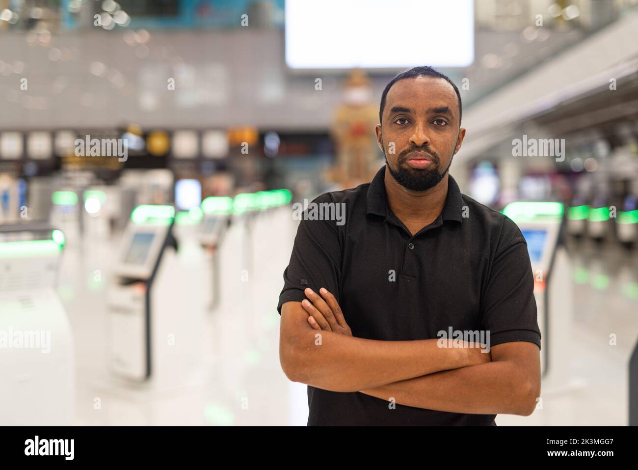 Portrait of African man ready to travel at airport terminal waiting for flight Stock Photo