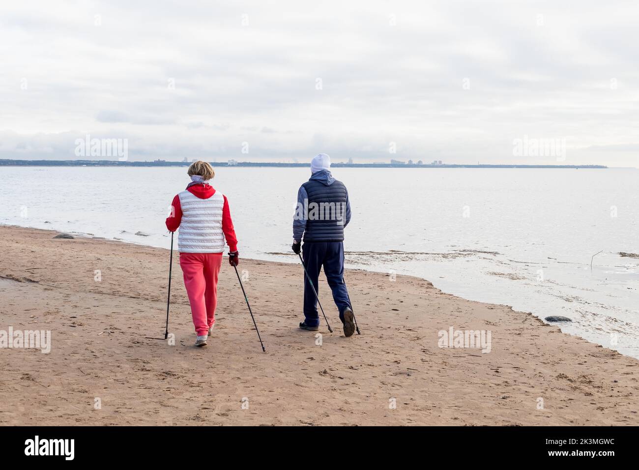 Nordic walking, rear view on elderly aged caucasian european couple