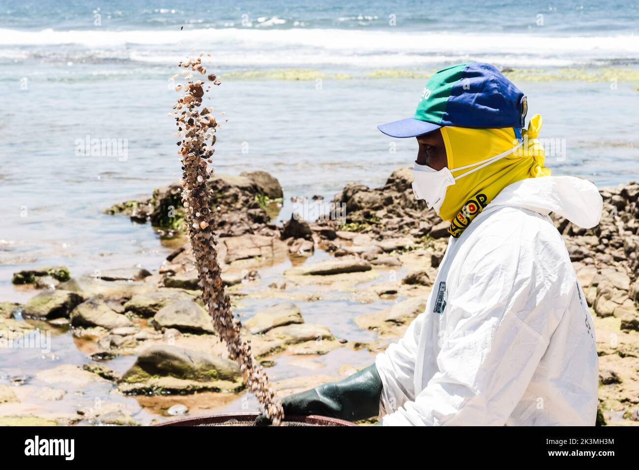 Salvador, Bahia, Brazil - October 26, 2019: Cleaning agents extract oil from Pedra do Sal beach in the city of Salvador. The site was affected by an o Stock Photo