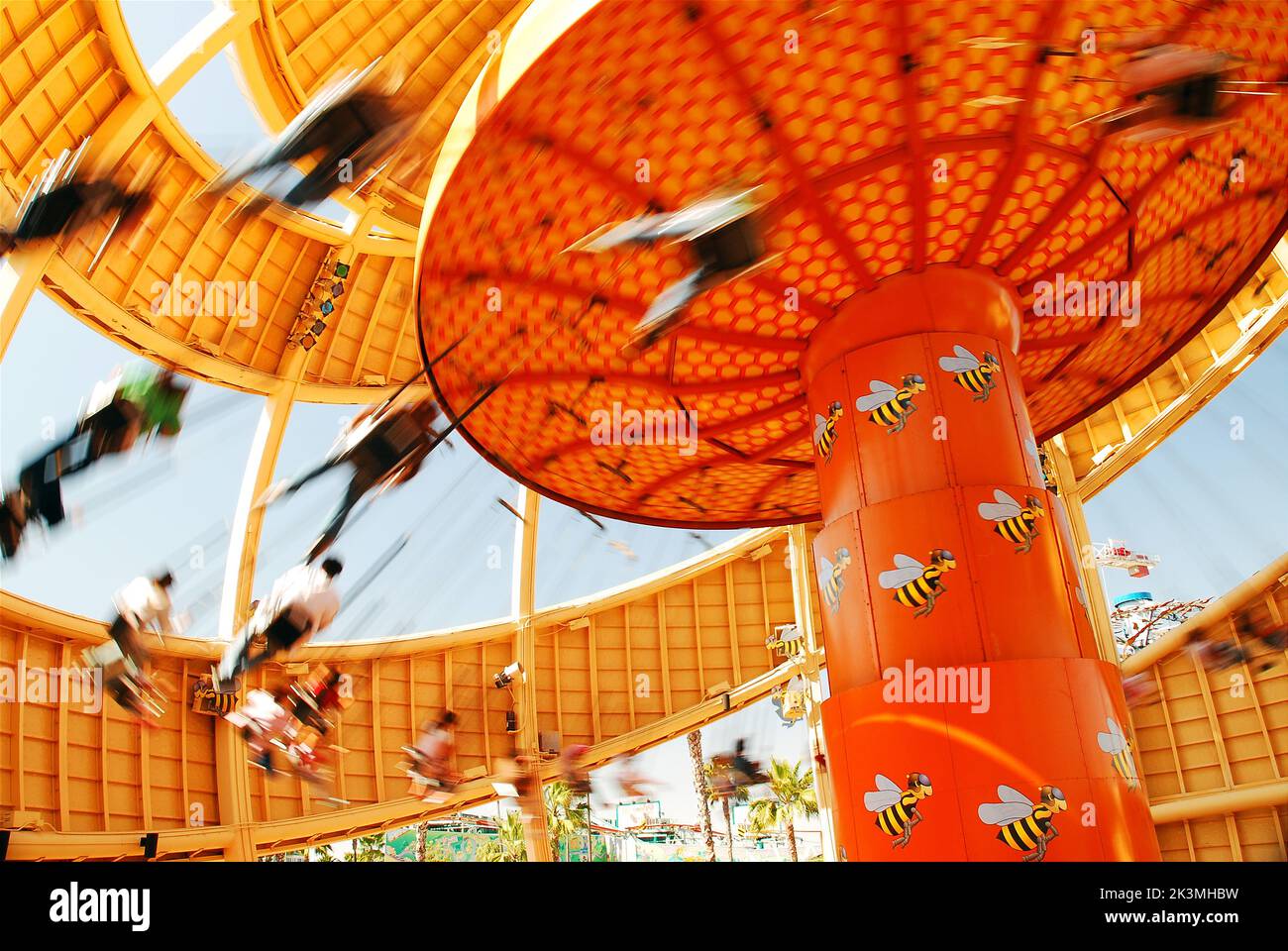 Riders make quick circles as they fly on the Orange Stinger swing ride, shaped like an orange, once an attraction in Disneyland's California Adventure Stock Photo