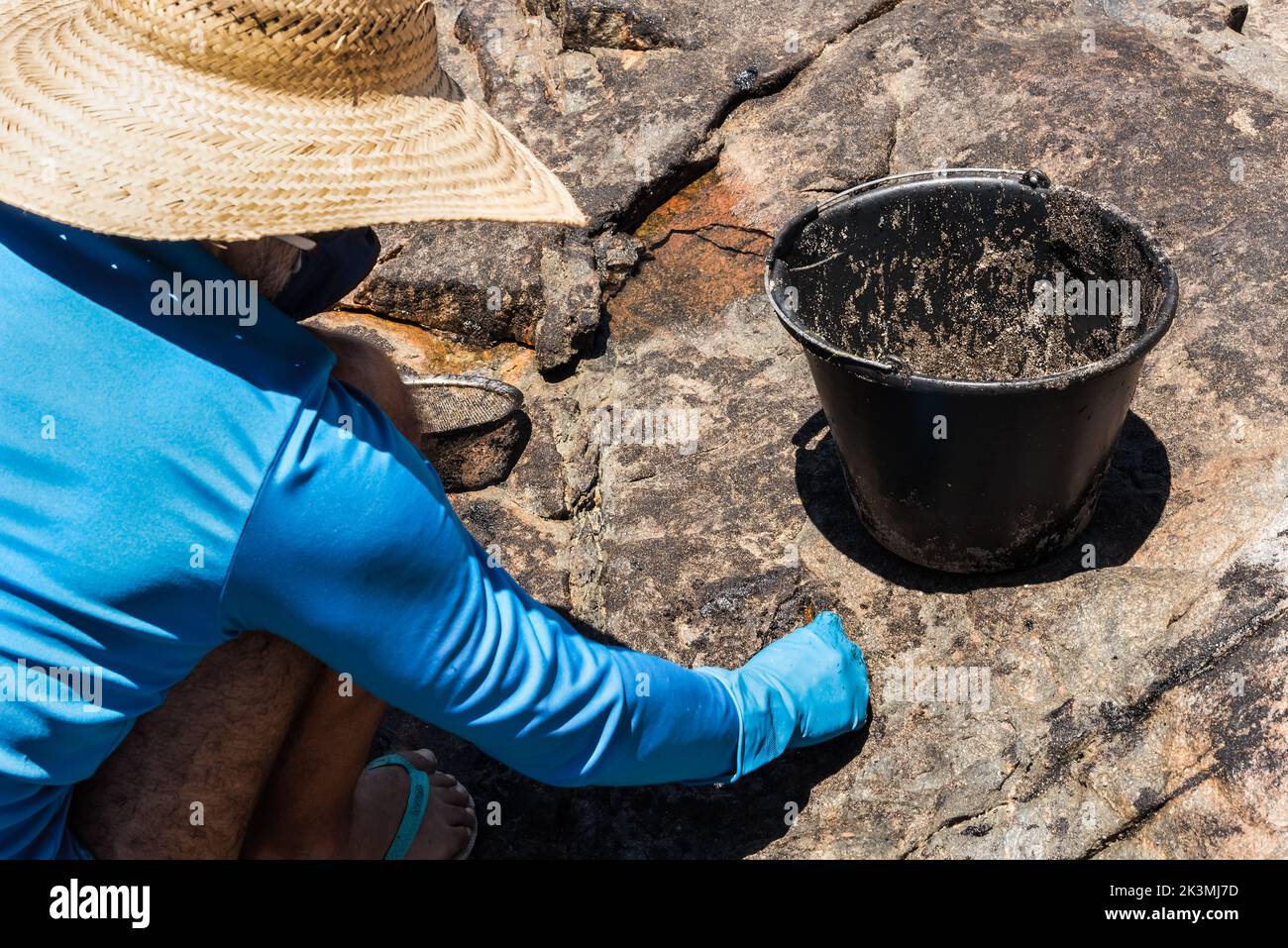 Salvador, Bahia, Brazil - October 26, 2019: Volunteers clean up oil at Pedra do Sal beach in the city of Salvador. The site was affected by an oil spi Stock Photo