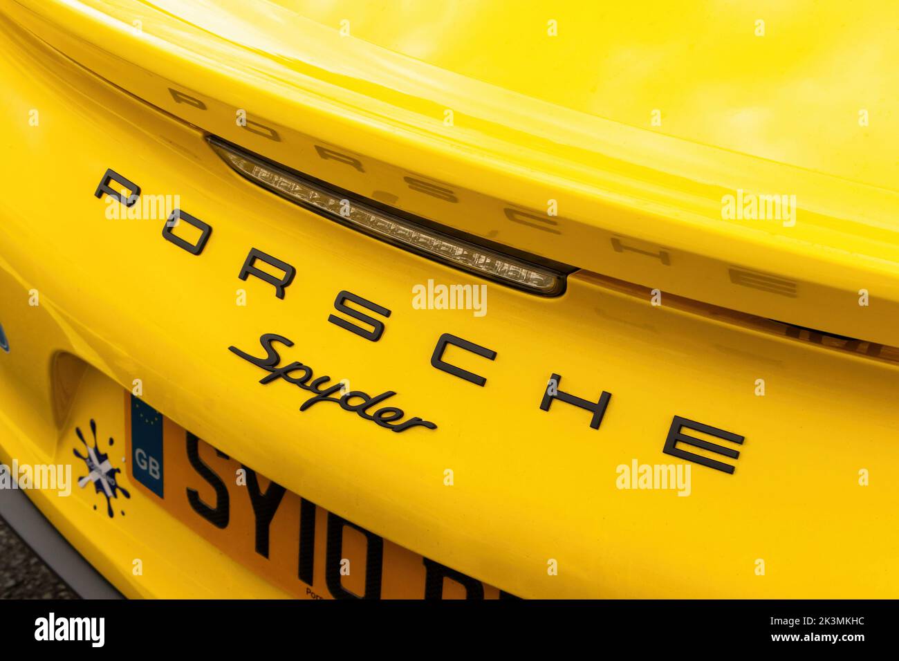 close up of yellow porsche  spyder badge logo on trunk or boot at the morgan car factory malvern worcestershire uk Stock Photo