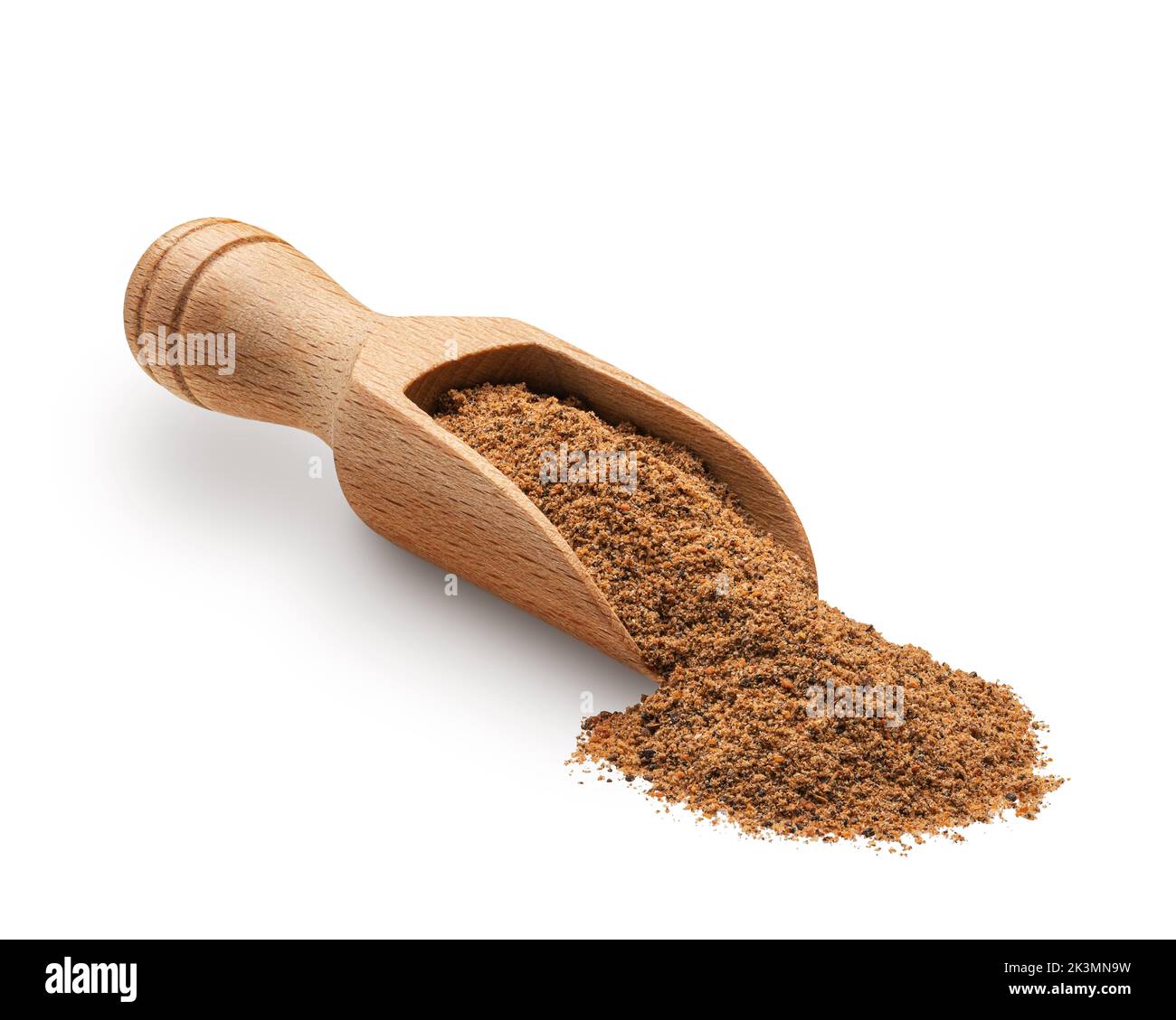 Nutmeg powder in a wooden scoop isolated on white background. Deep focus Stock Photo