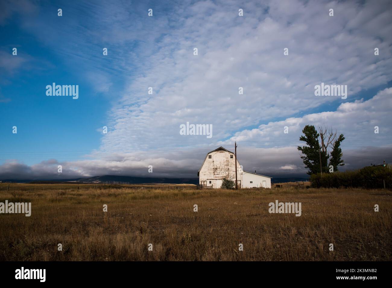 White barn and farmhouse in Deer Lodge, Montana, USA. Montana is known