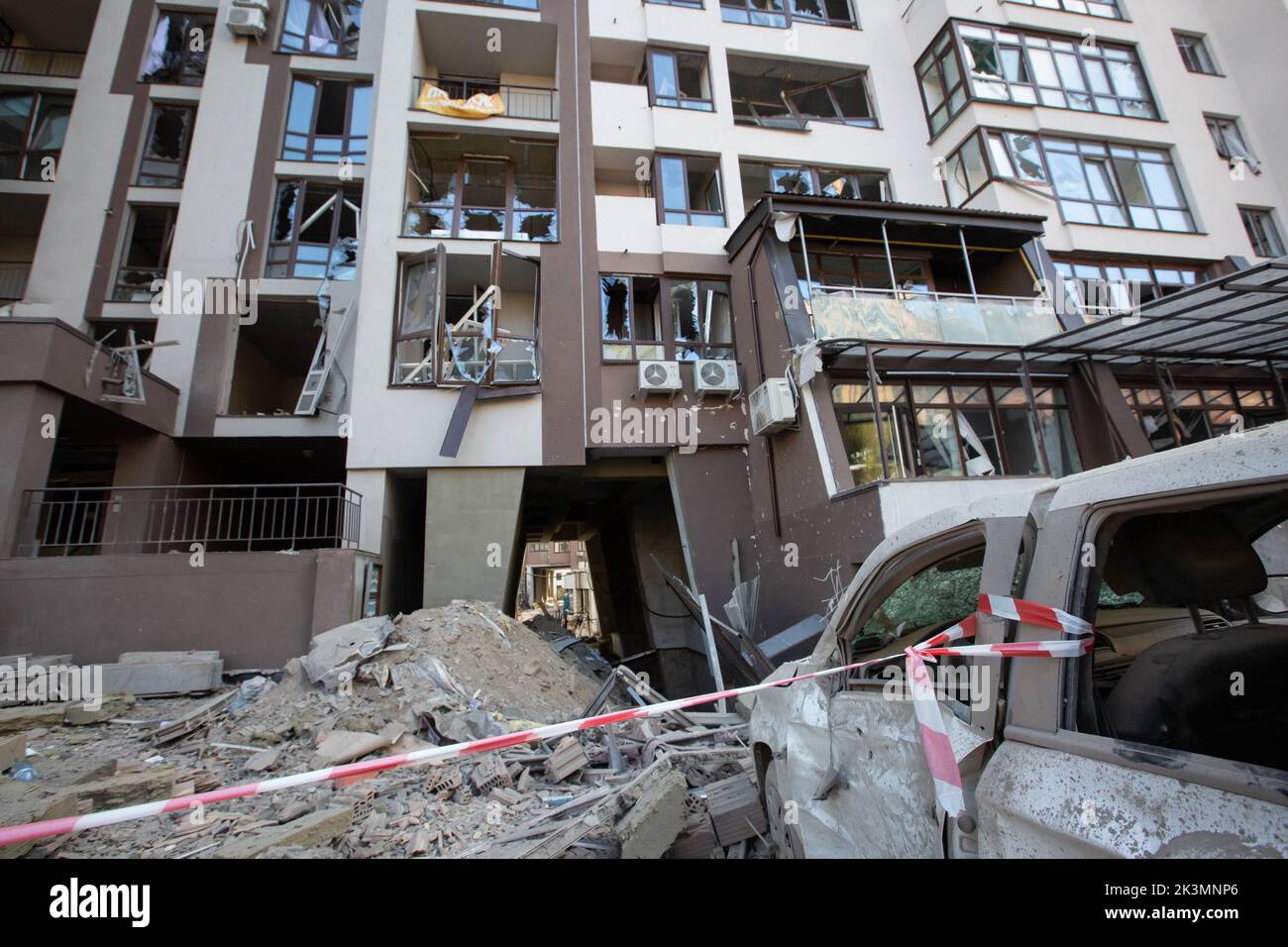 Car parked near an apartment building destroyed in a military strike ...