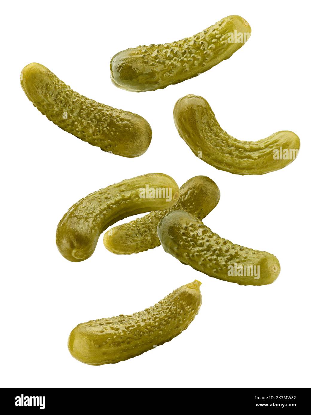 Falling marinated pickled cucumbers isolated on white background