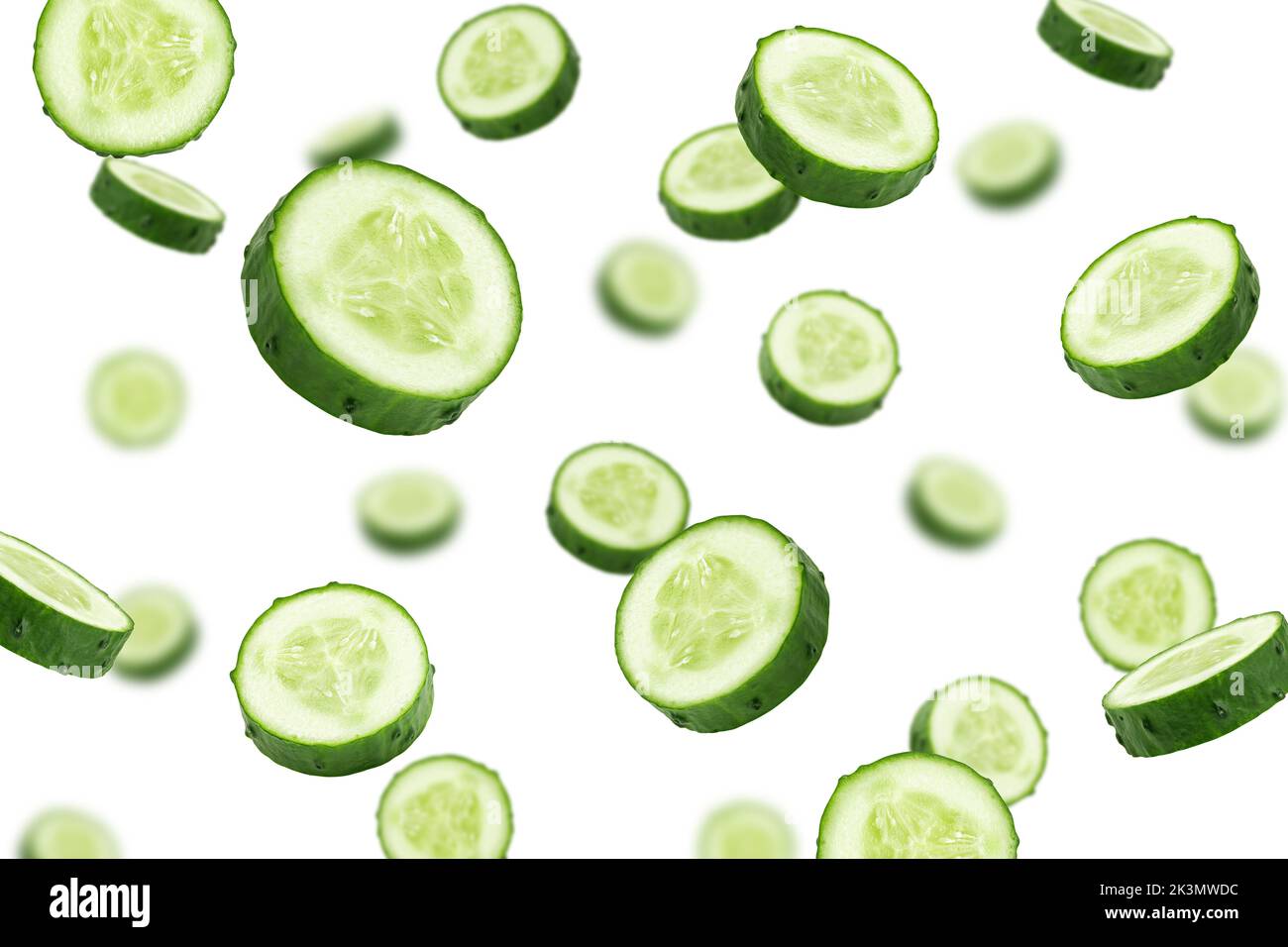 Falling cucumber slice isolated on white background, selective focus Stock Photo