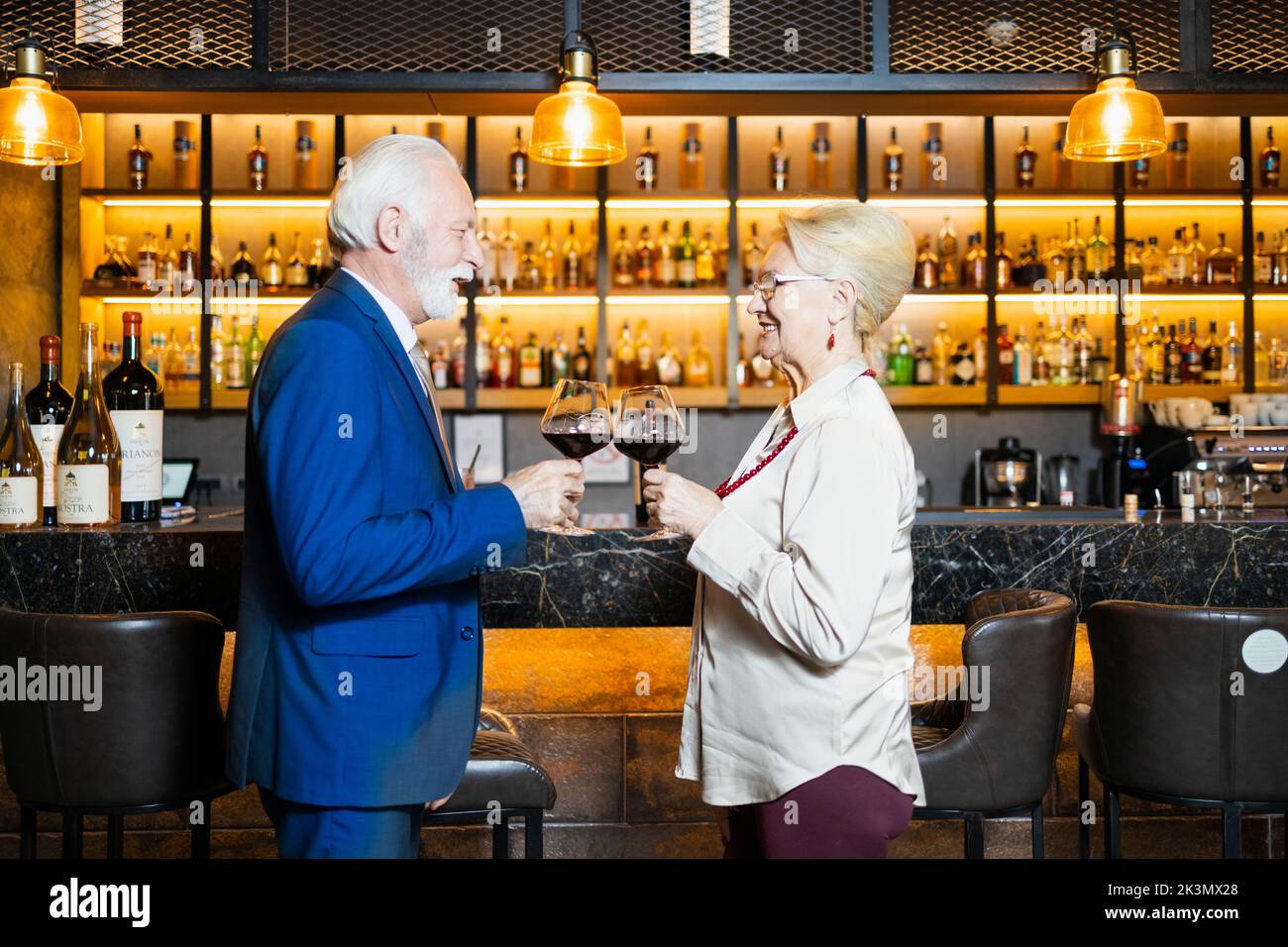 Two people making a toast with at the bar Stock Photo