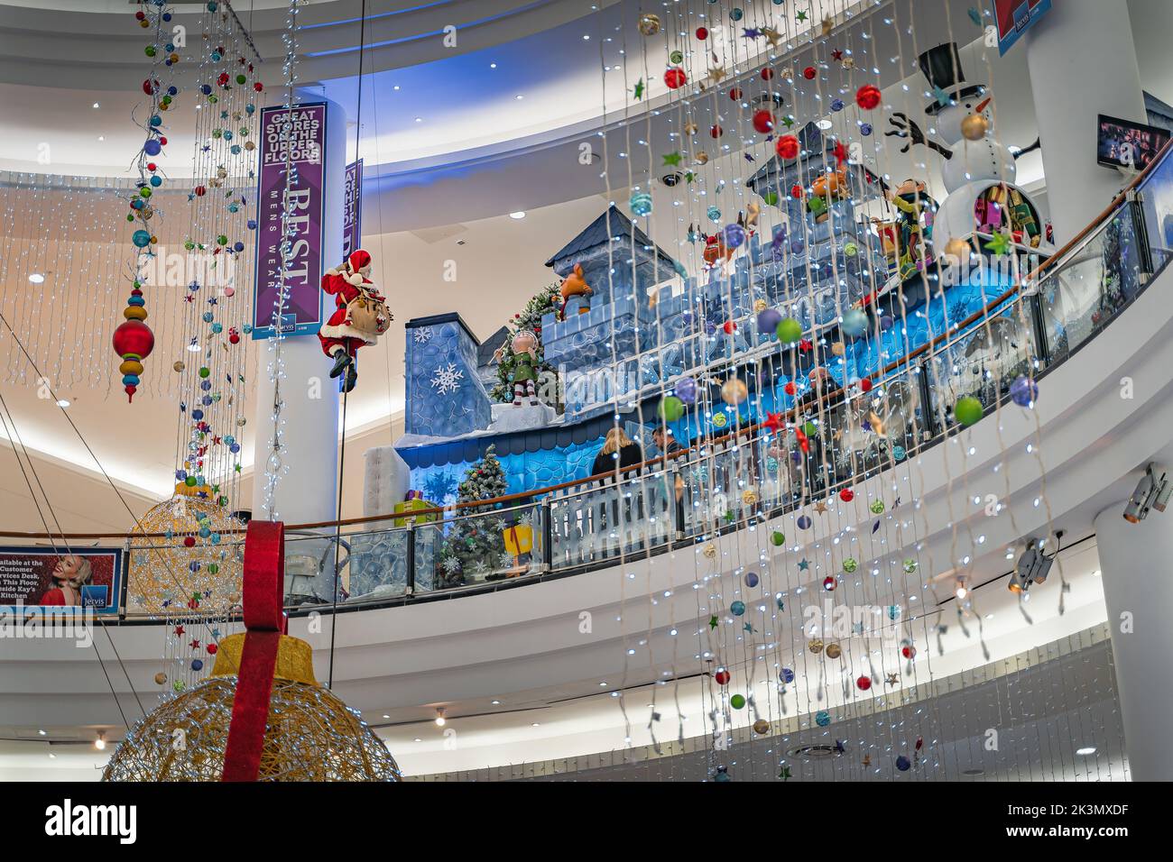 Dublin, November 2019 Santa Claus climbing on a rope, Christmas balls snowman and decorations in Jervis Shopping Centre. Santa grotto or winter castle Stock Photo