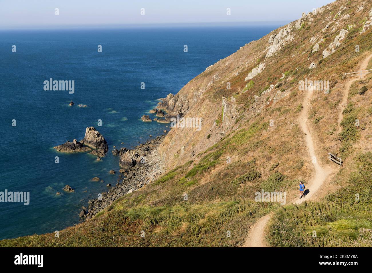 Woman hiking on a footpath around the Cotentin peninsula, Normandy, France Stock Photo