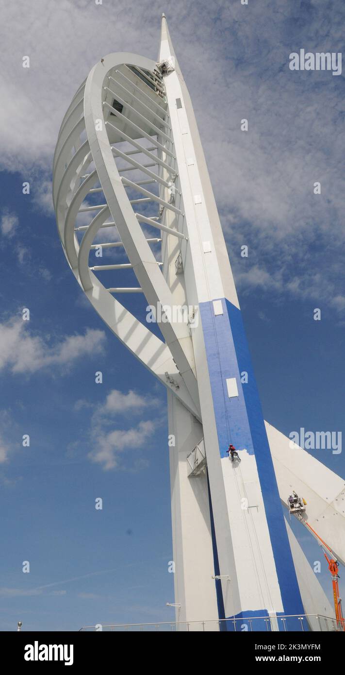 High roller Irina Gola has been making a splash with several thousands of litres of paint while she carries out a towering job with a difference – turning the tallest building outside London from white to blue and gold.     Irina is part of an army of painters drafted in to transform the 560ft high Spinnaker Tower in Port  smouth into the colours of new sponsors, Emirates Airlines.     The colouring has been the subject of controversy because the airline’s colours are gold and red and the tower was to have been painted red and gold until an online protest petition gathered 10,000 signatures. E Stock Photo