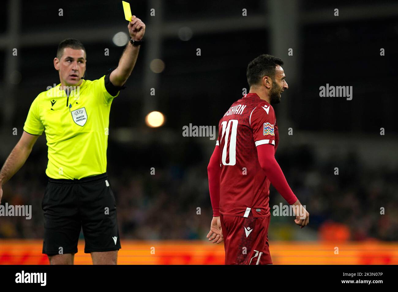 Armenia's Artak Dashyan (right) is shown a yellow card by referee Rade Obrenovie during the UEFA Nations League match at the Aviva Stadium in Dublin, Ireland. Picture date: Tuesday September 27, 2022. Stock Photo
