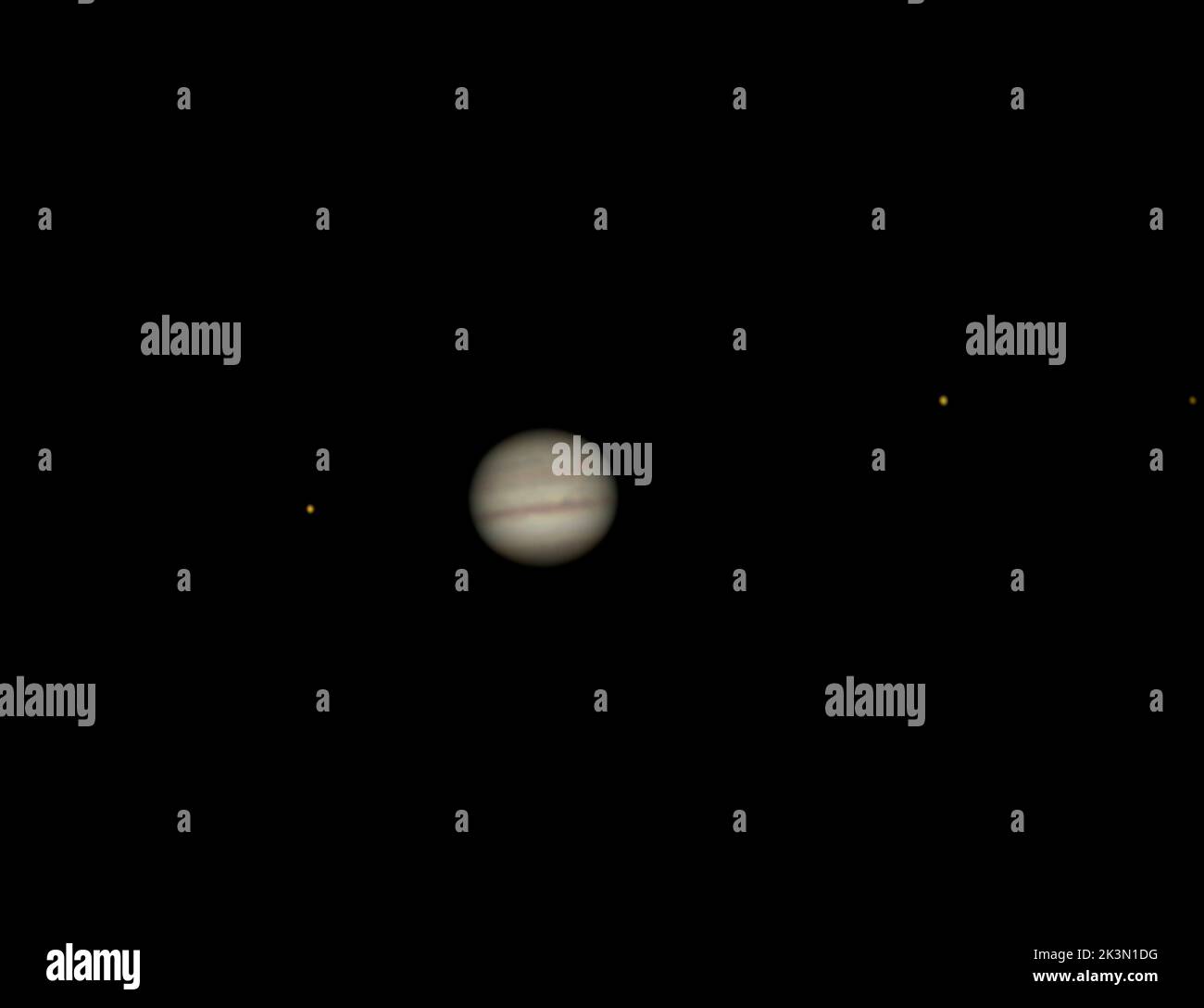Telescope view of the planet Jupiter and its 4 moons left to