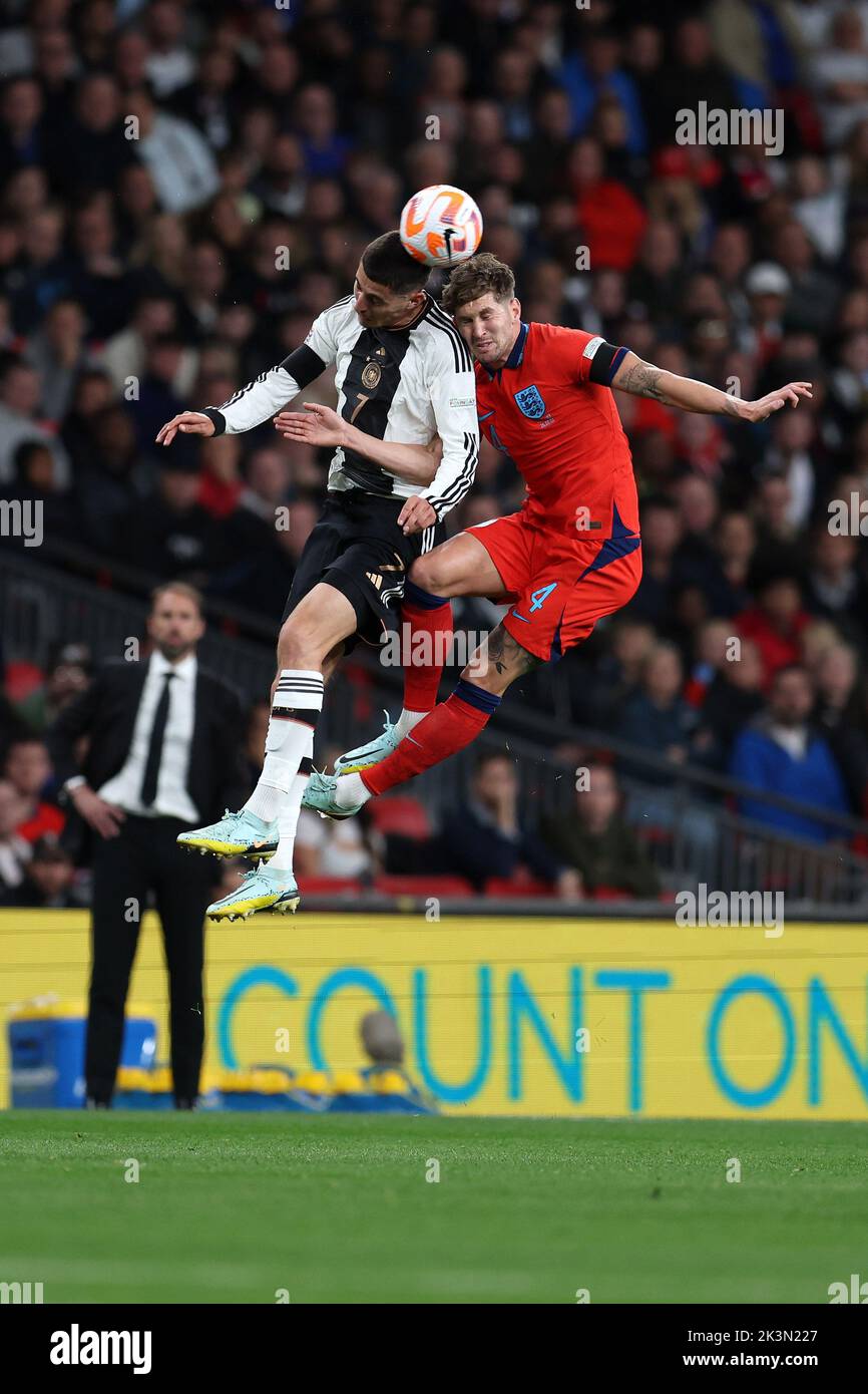 London, UK. 26th Sep, 2022. John Stones of England (r) jumps for a header with Kai Havertz of Germany (l). England v Germany, UEFA Nations league International group C match at Wembley Stadium in London on Monday 26th September 2022. Editorial use only. pic by Andrew Orchard/Andrew Orchard sports photography/Alamy Live News Credit: Andrew Orchard sports photography/Alamy Live News Stock Photo