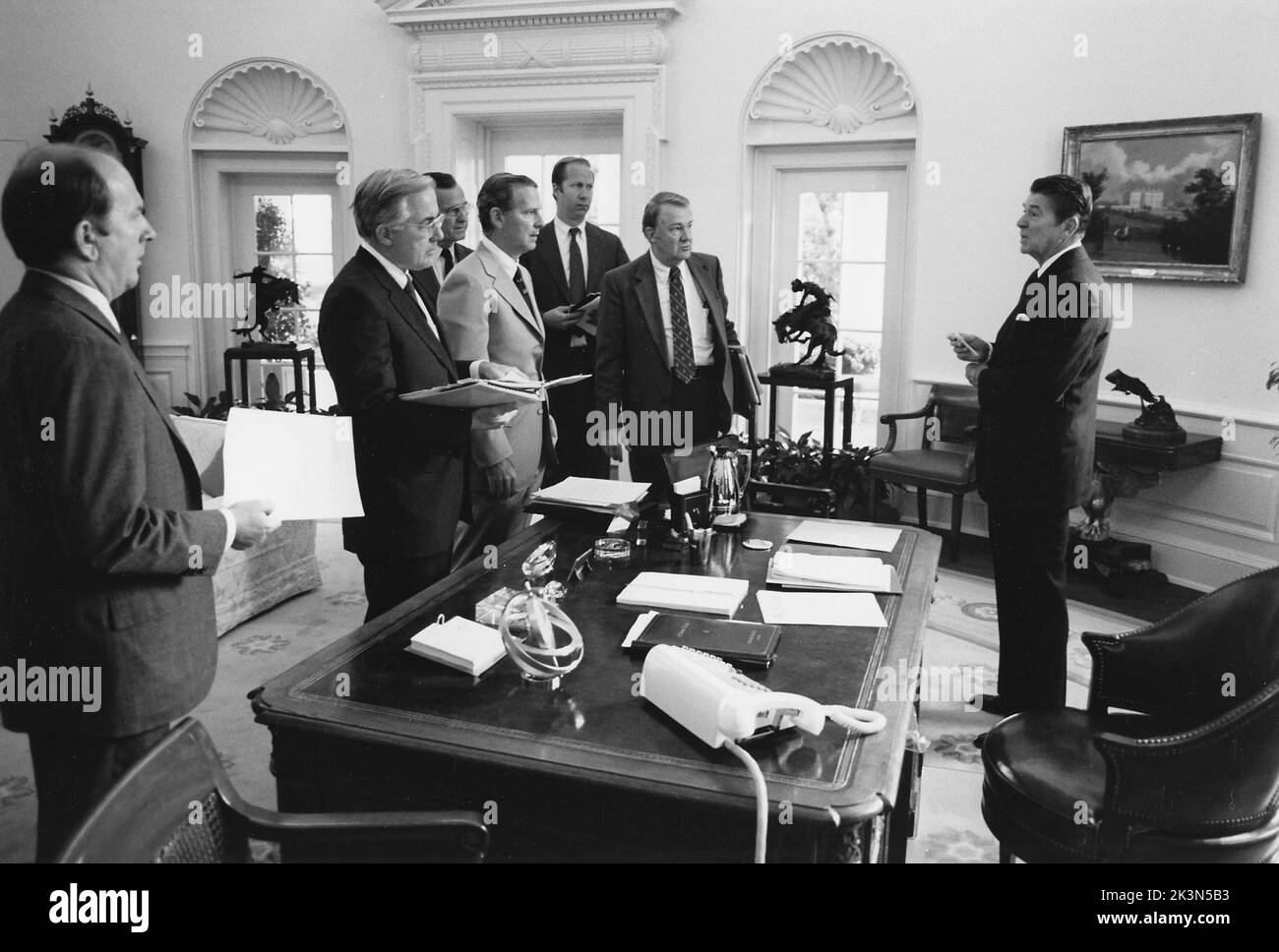 President Reagan and his White House staff discussing the assassination of Egyptian President Anwar Sadat Stock Photo
