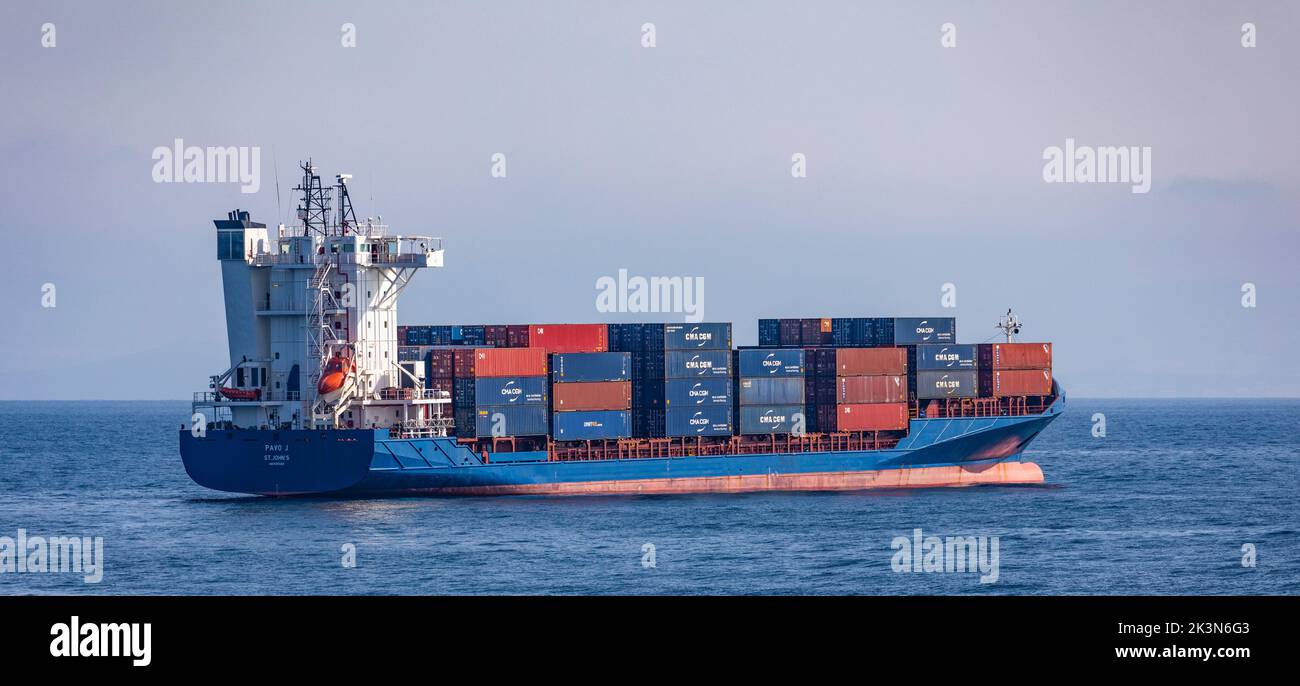 The Container Ship Pavo J loaded with containers in the Firth of Clyde between mainland North Ayrshire and the Island of Arran. Stock Photo