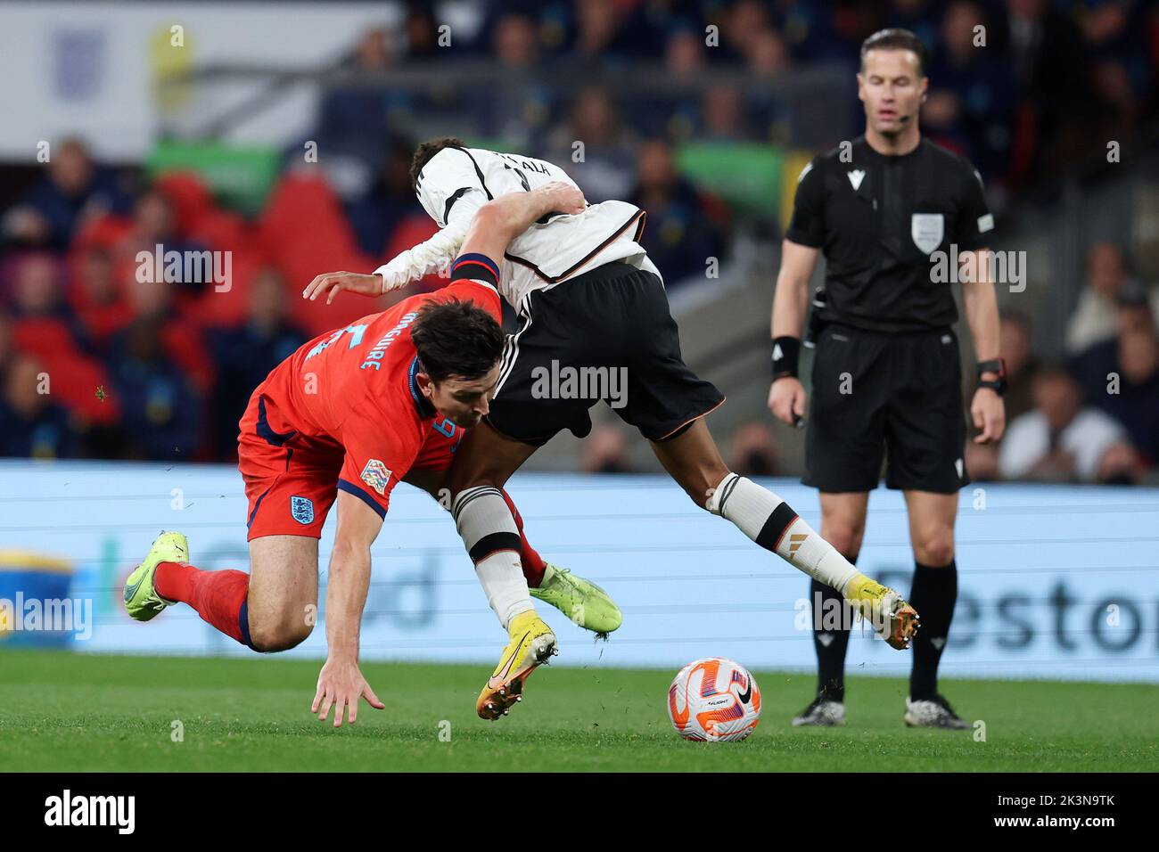 London, UK. 26th Sep, 2022. Harry Maguire of England (l) tackles Jamal Musiala of Germany. England v Germany, UEFA Nations league International group C match at Wembley Stadium in London on Monday 26th September 2022. Editorial use only. pic by Andrew Orchard/Andrew Orchard sports photography/Alamy Live News Credit: Andrew Orchard sports photography/Alamy Live News Stock Photo