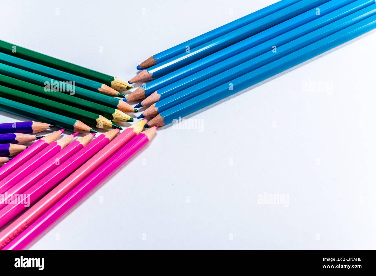 Green blue pink and lilac wooden pencils isolated on white background. close up Stock Photo