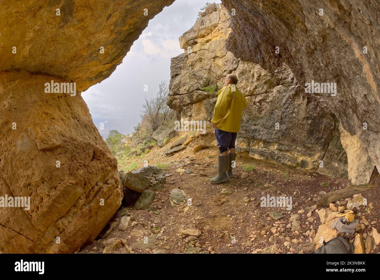 Grand Canyon Hiker Sheltering in Cave Stock Photo