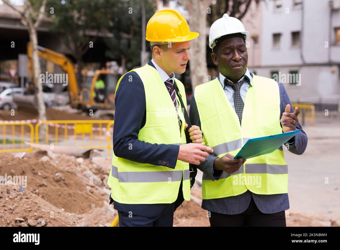 Two workers are studying a folder with important working papers Stock ...