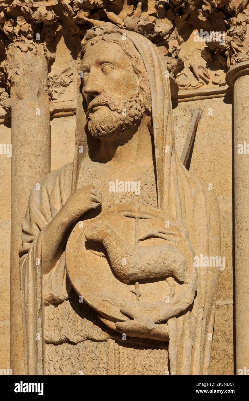 Statue of Saint John the Baptist holding the Lamb of God on the face of Reims Cathedral (a UNESCO World Heritage Site) in Reims (Marne), Fran Stock Photo
