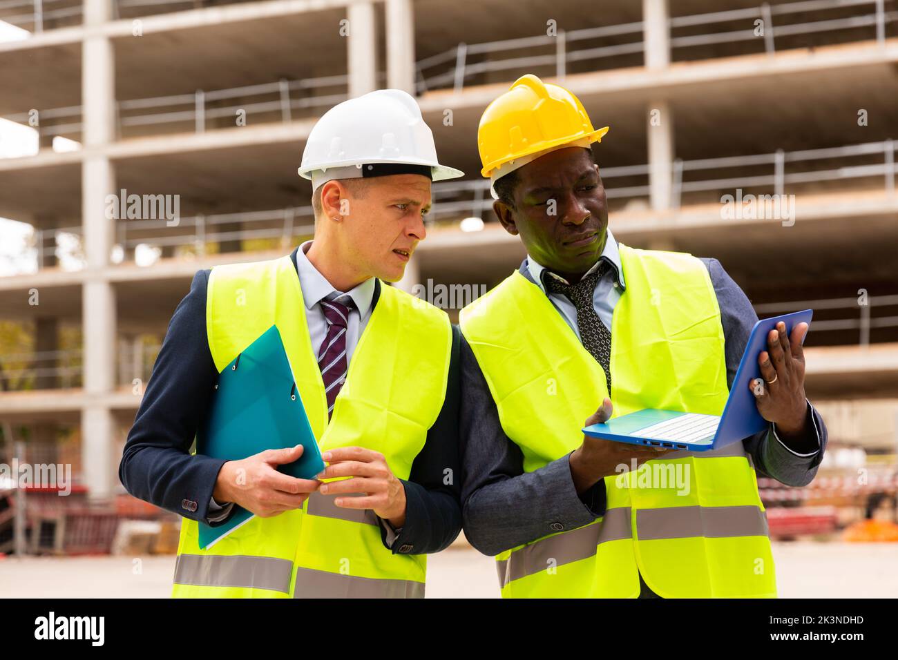 Two civil engineers contols the progress of work on a laptop Stock Photo