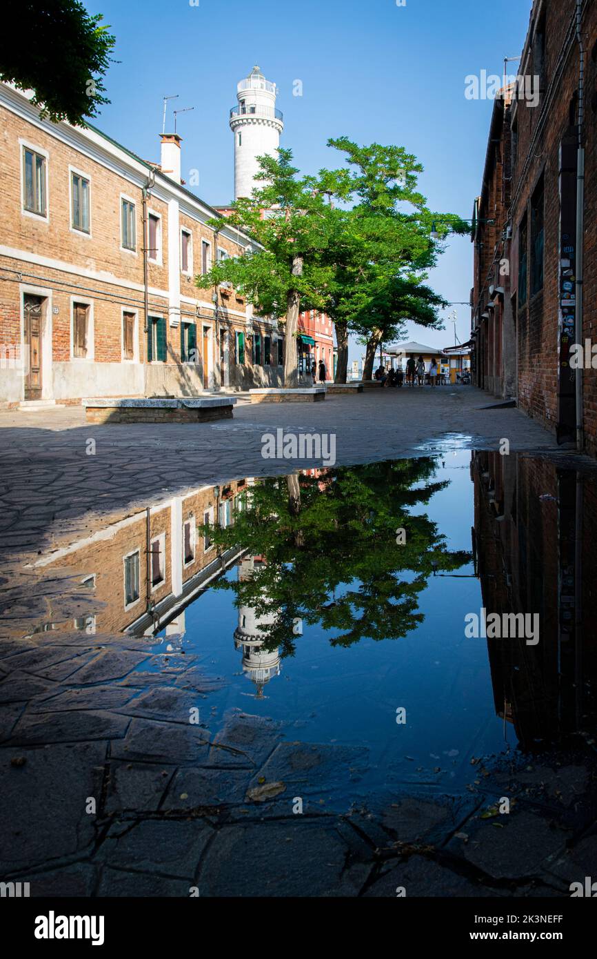 The Murano lighthouse reflected in water, Murano, Venice Stock Photo