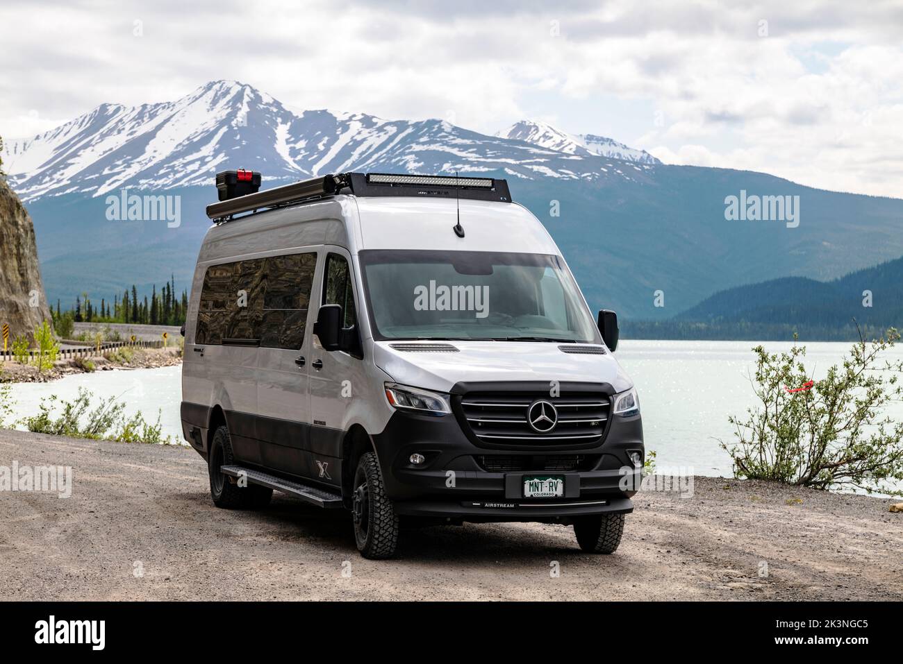 Recreational vehicle along the Alaska Highway and Muncho Lake; surrounded by Canadian Rocky Mountains; British Columbia; Canada Stock Photo